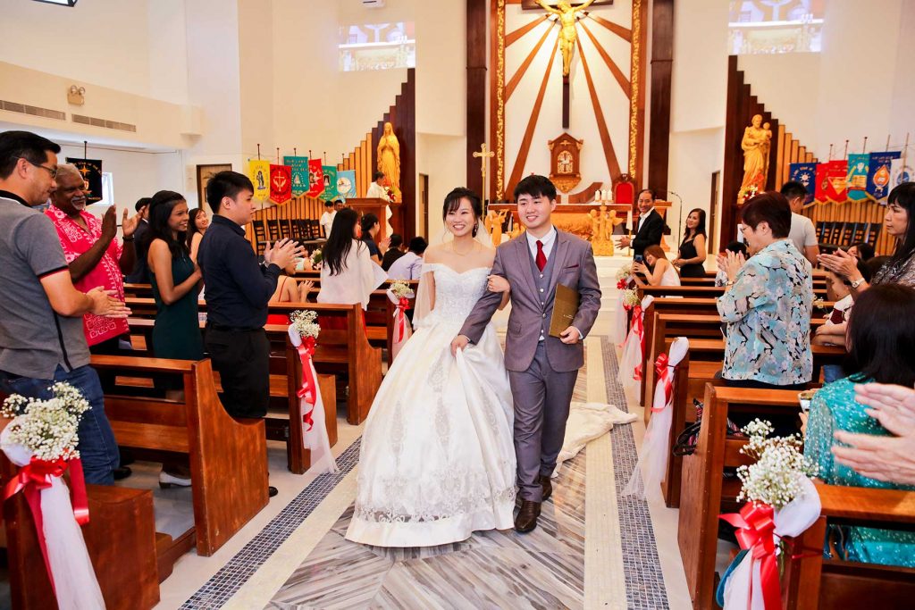 Bridesmaids in blue dresses with rose petals at outdoor wedding ceremony Singapore