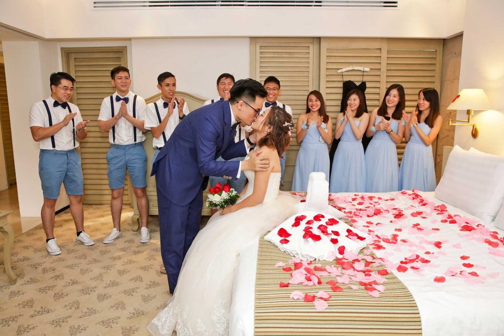 Casual groomsmen in suspenders and shorts at outdoor garden wedding Singapore