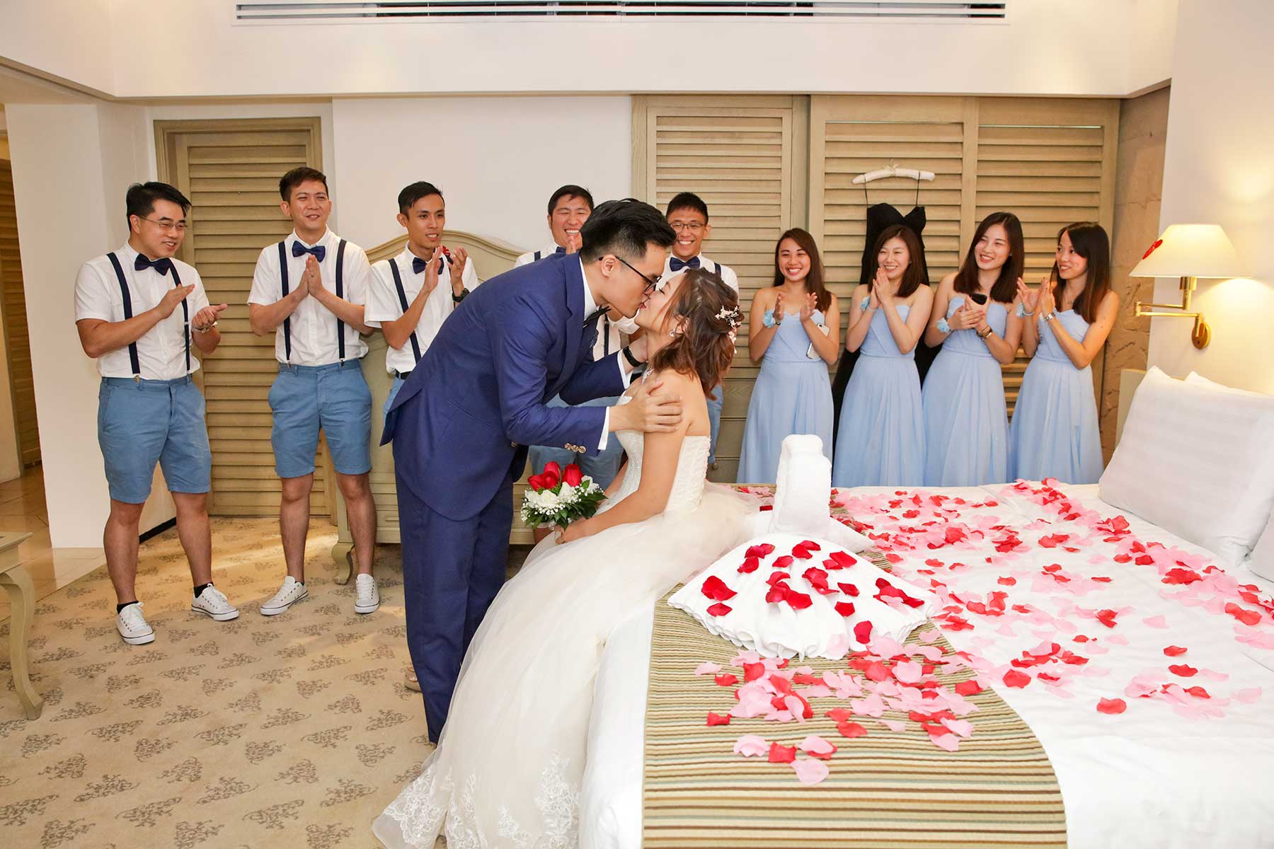 Casual groomsmen in suspenders and shorts at outdoor garden wedding Singapore