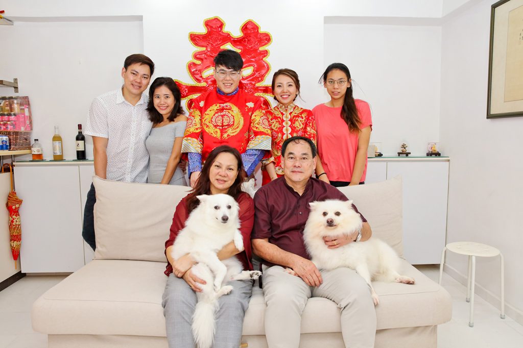 Fun Chinese wedding family photo with couple in traditional kua and pet dogs Singapore